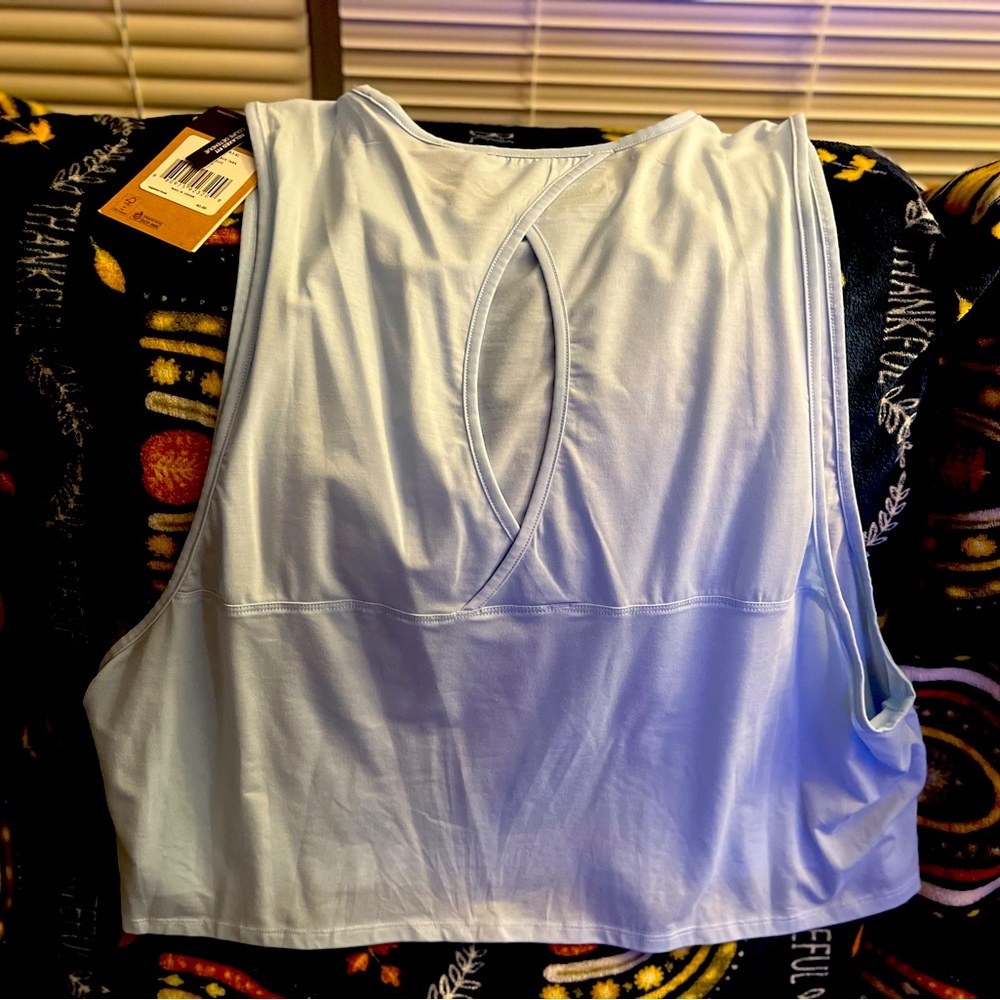 Brand new with tags, runs small, it’s a crop top type shirt